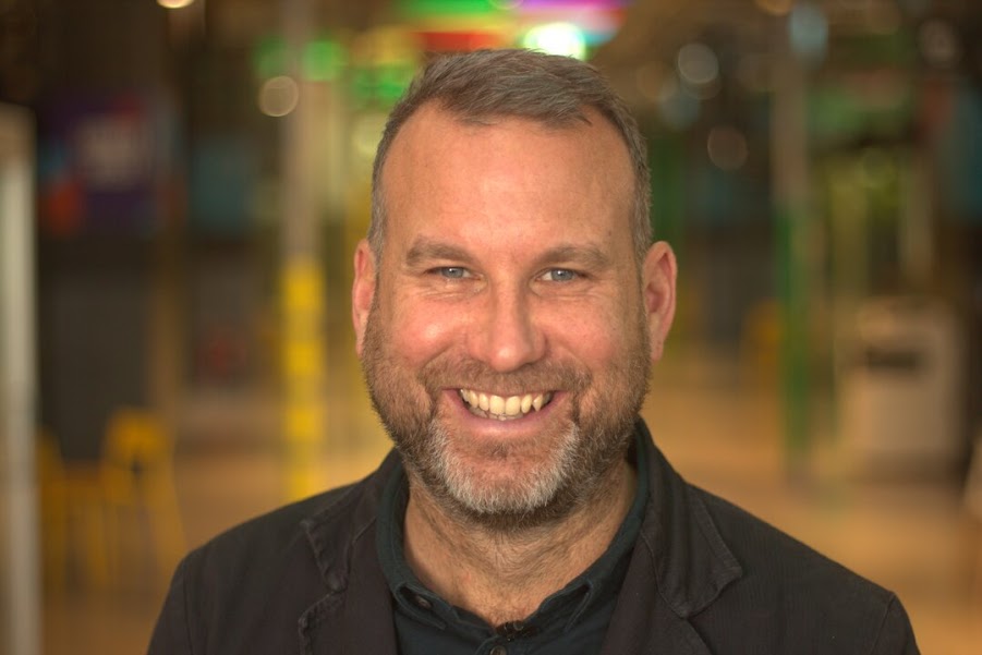 A headshot of Aphetor founder Carsten Thode. He's smiling and wearing a black jacket.